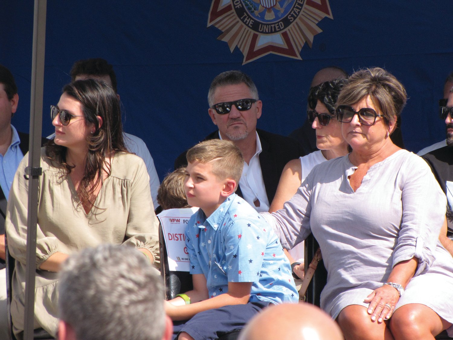 SORROW AND PRIDE: From left, Adam DeCiccio’s fiancée Tayla Inderlin, son Gunner and mother Dawn look on during the weekend’s rededication ceremony.